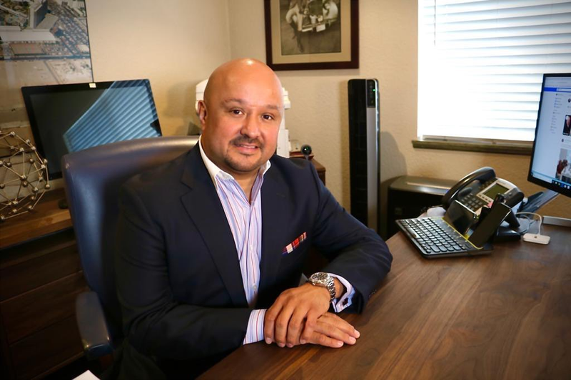 Jesse Fonseca at his desk at the Park Place Realty office on Jones Boulevard
