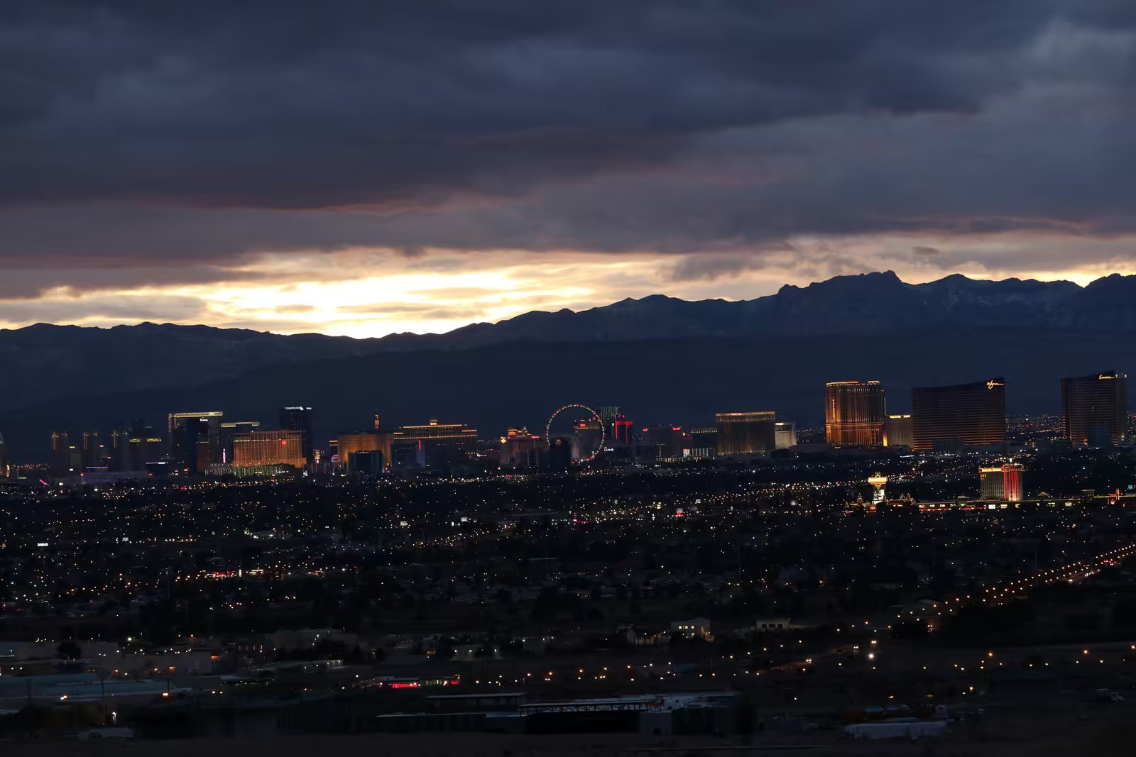 The Las Vegas Strip at dusk with the snow-dusted Spring Mountains behind